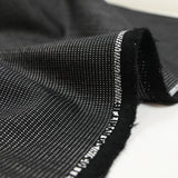 Tela de traje mezcla de lino y lana con puntitos blancos y grises con fondo negro