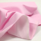 Piqué de coton imprimé à pois fond rose