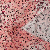 Voile de viscose imprimé fleurs dansantes fond rose brumeux