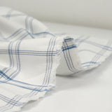 Coton tissé teint carreaux trait bleu fond blanc