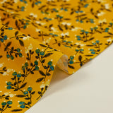 Popeline de coton imprimée pousse fleurie bleu fond jaune soleil