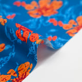Popeline de coton imprimée fleur stylisée orange fond turquoise