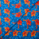 Popeline de coton imprimée fleur stylisée orange fond turquoise