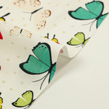 Popeline de coton imprimée papillon pois beige fond blanc