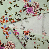 Popeline de coton imprimée fleur arabesque violet fond vert de gris