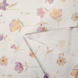 Popeline de coton imprimée fleurs pastel mauve et pêche fond blanc