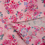 Popeline de coton imprimée bouquet de fleurs fuchsia fond rose dragée