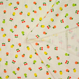 Jersey pointelle coton imprimé tutti frutti fond blanc cassé