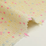 Tweed de laine mélangée confettis rose et bleu fond jaune