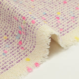 Tweed de laine mélangée confettis rose et bleu fond violet