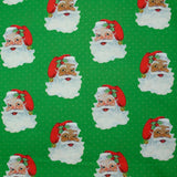 Coton imprimé père Noël à pois fond vert