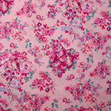 Popeline de coton imprimée bouquet de fleurs fuchsia fond rose dragée
