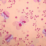 Popeline de coton imprimée papillon fond rose poudre