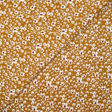 Viscose imprimée fleurs blanches et bordeaux fond ocre