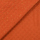 Double gaze matelassé orange confettis doré vendu au mètre